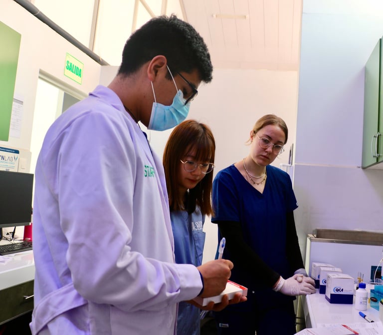 Three healthcare workers in a clinical laboratory setting, examining medical samples or equipment, wearing masks and protective gloves